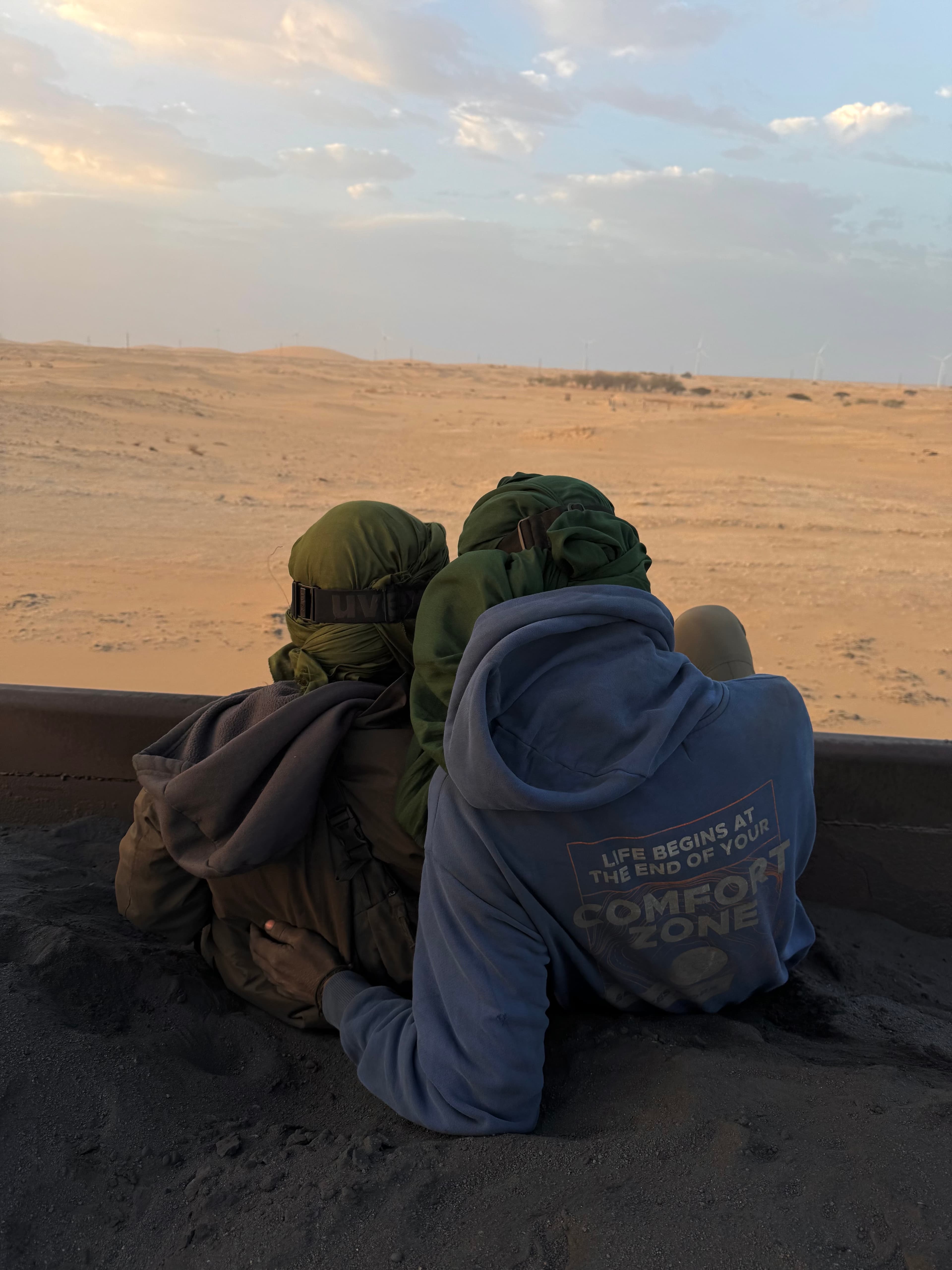 Silvia and Emilio travelling together on a train through the Sahara